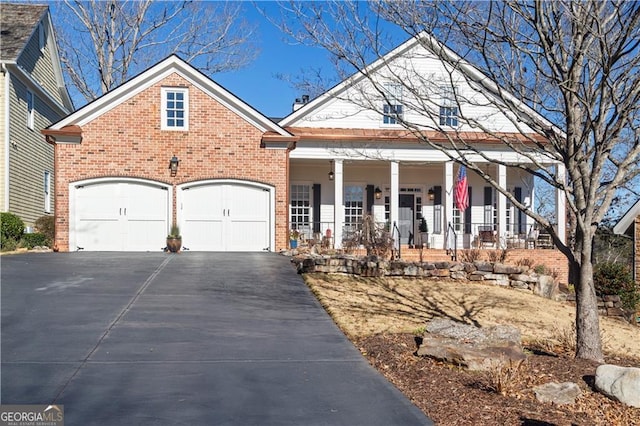 view of front of house featuring covered porch and a garage