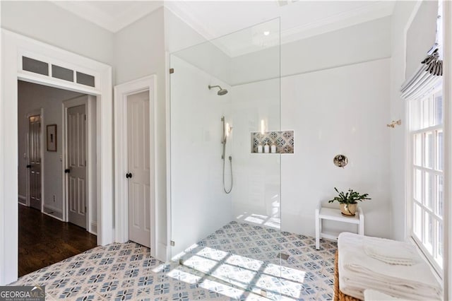 bathroom with a tile shower, crown molding, and hardwood / wood-style flooring