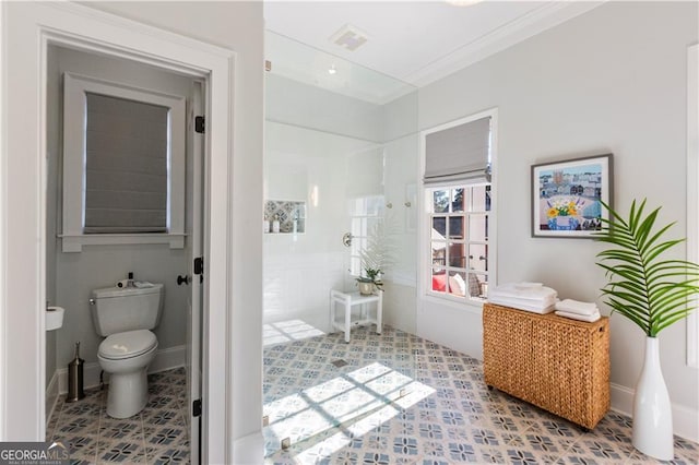 bathroom with toilet, walk in shower, and ornamental molding