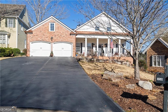 front of property featuring covered porch and a garage