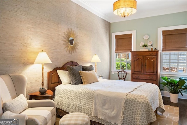 bedroom with hardwood / wood-style floors and ornamental molding