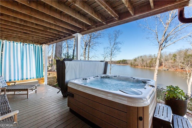 wooden terrace with a water view and a hot tub