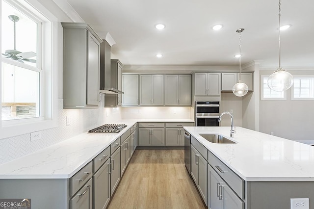 kitchen featuring pendant lighting, appliances with stainless steel finishes, gray cabinetry, and sink