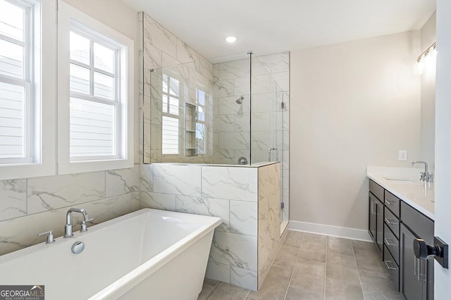 bathroom with vanity and separate shower and tub