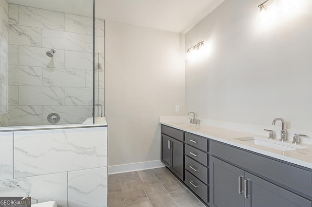 bathroom with vanity and tiled shower