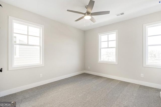 spare room with carpet flooring and ceiling fan