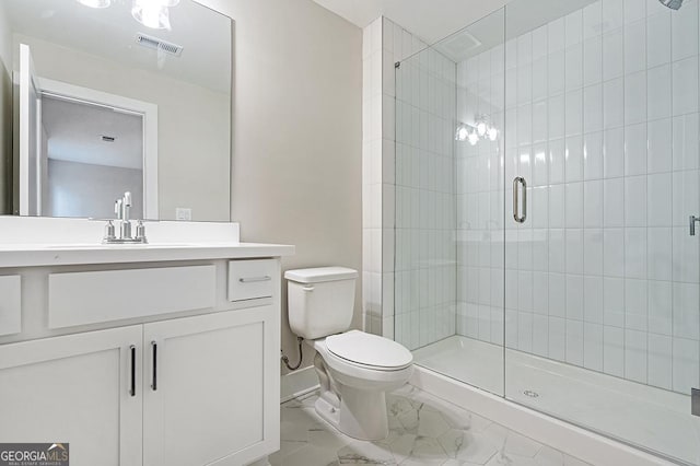 bathroom with vanity, toilet, and a shower with shower door