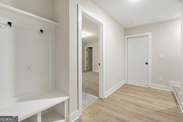 mudroom with light hardwood / wood-style flooring