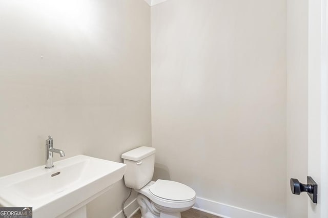 bathroom featuring toilet and sink