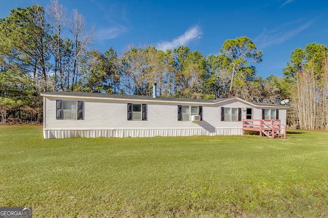 manufactured / mobile home featuring cooling unit and a front lawn