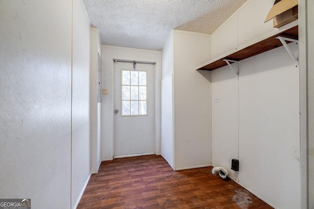 clothes washing area featuring a textured ceiling and dark wood-type flooring