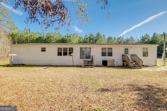 back of property featuring a lawn