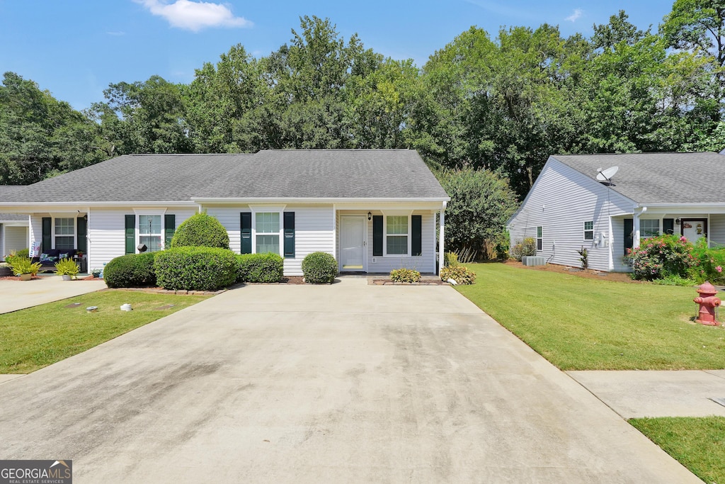 single story home featuring central AC unit and a front yard