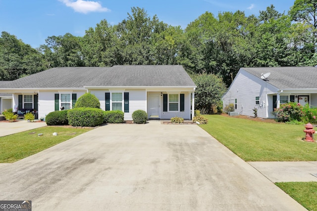 single story home featuring central AC unit and a front yard