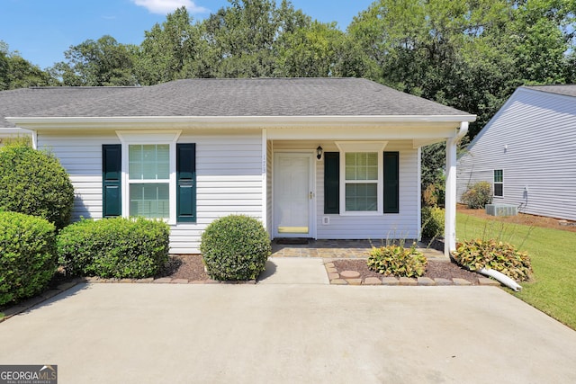 view of front of house with covered porch and central AC