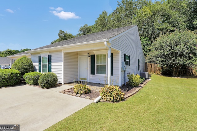 single story home with central AC unit and a front yard