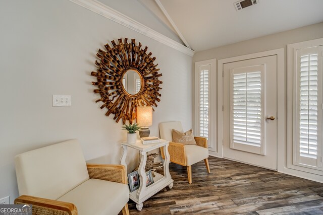 living area featuring ornamental molding, dark hardwood / wood-style flooring, plenty of natural light, and lofted ceiling