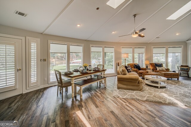 sunroom / solarium featuring vaulted ceiling with skylight and ceiling fan