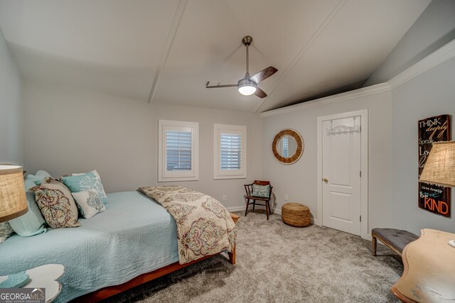 carpeted bedroom with ceiling fan and vaulted ceiling