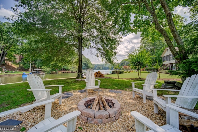 view of yard with a water view and an outdoor fire pit