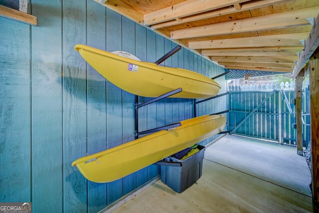 exterior space featuring wood walls and lofted ceiling