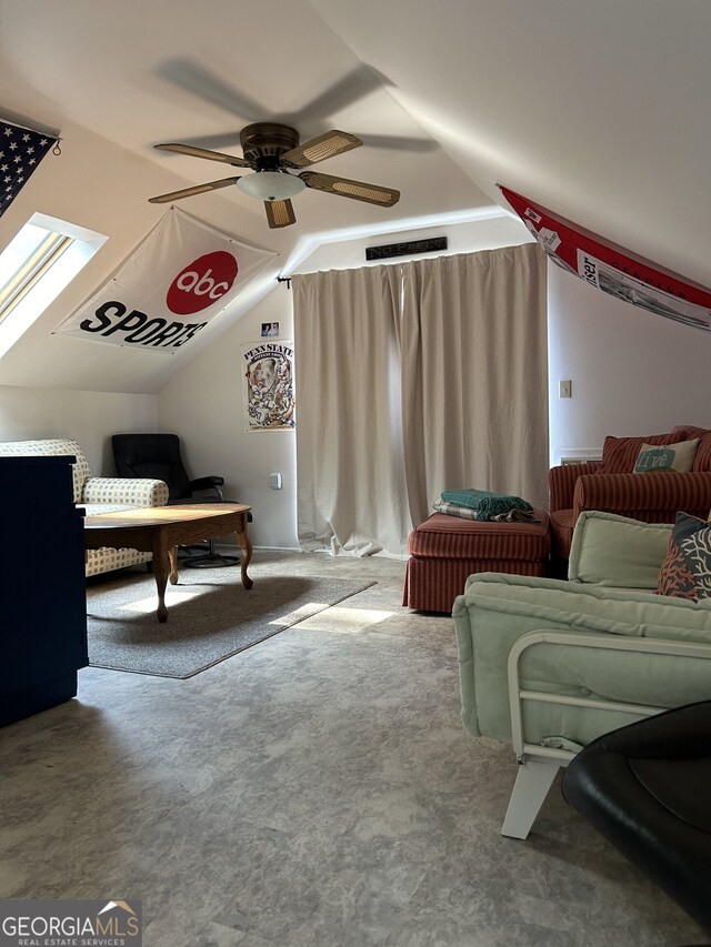 interior space with ceiling fan and vaulted ceiling with skylight