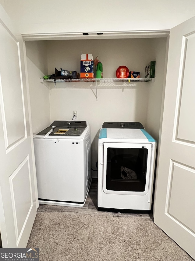 clothes washing area featuring separate washer and dryer