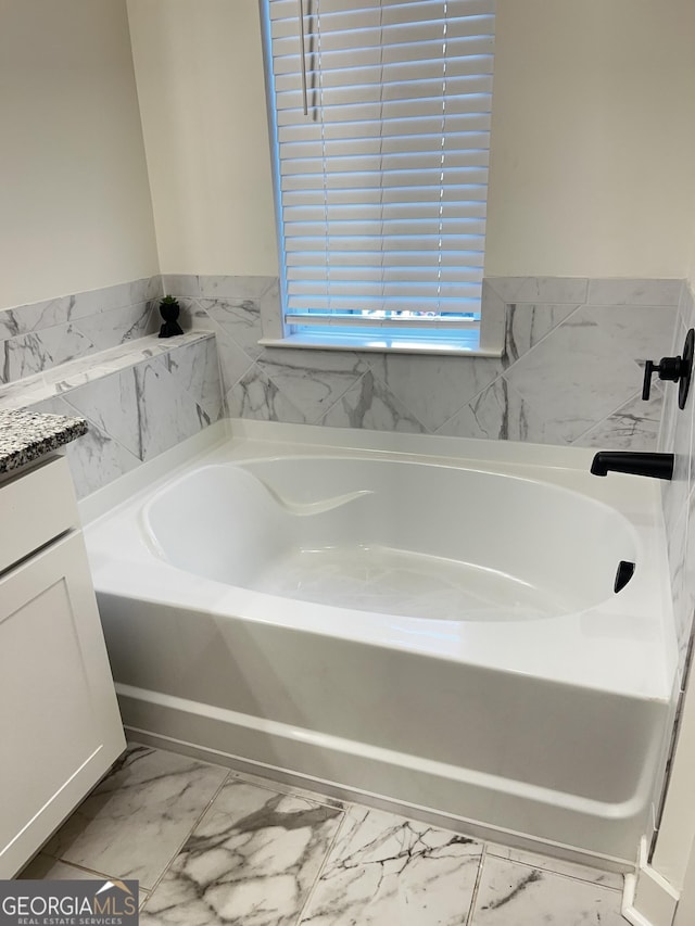 bathroom with vanity and a bathing tub