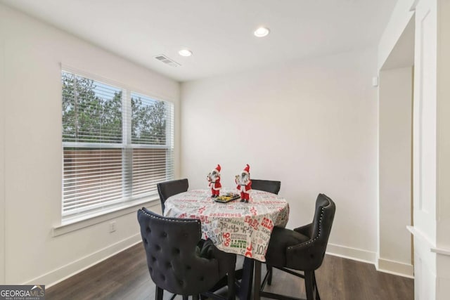 dining room featuring a healthy amount of sunlight and dark wood-type flooring