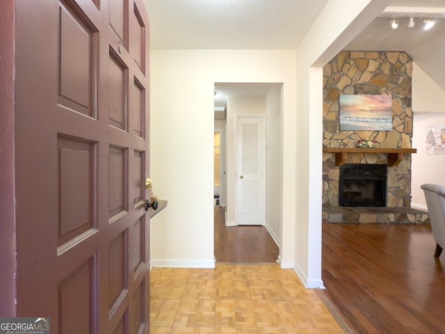 hall featuring a textured ceiling and light parquet floors