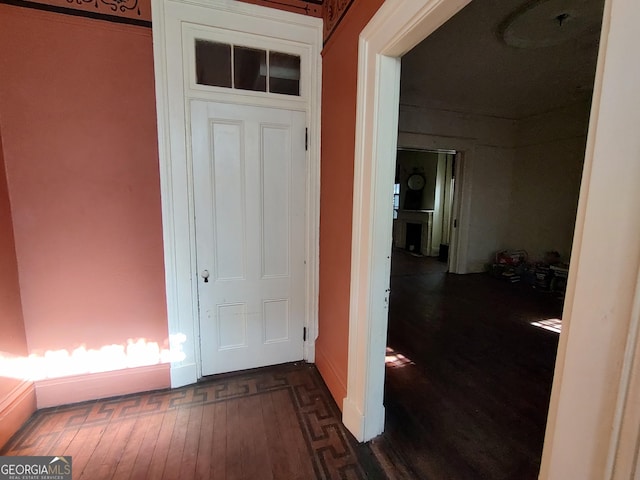 corridor featuring dark hardwood / wood-style flooring