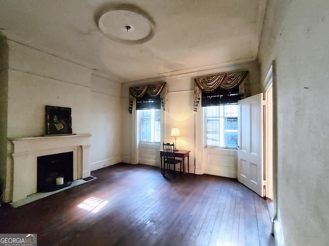 unfurnished living room with dark wood-type flooring