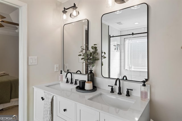 ensuite bathroom featuring double vanity, ensuite bath, and a sink