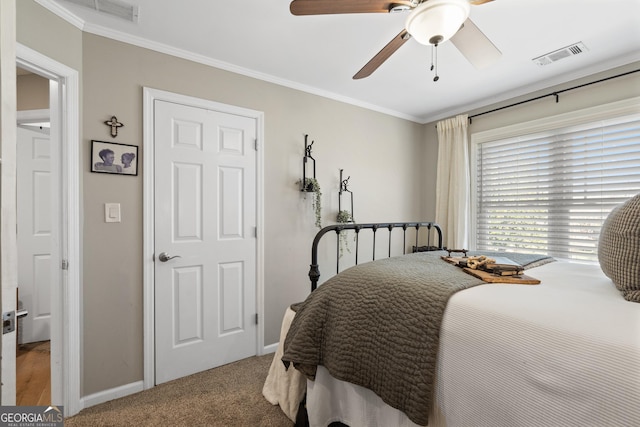 bedroom featuring light carpet, baseboards, visible vents, and crown molding