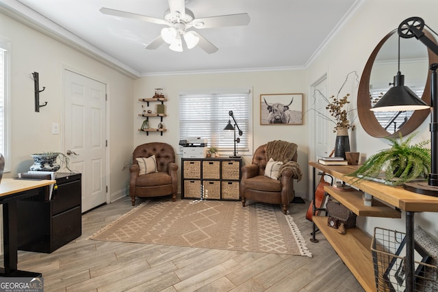 sitting room with ceiling fan, wood finished floors, and crown molding