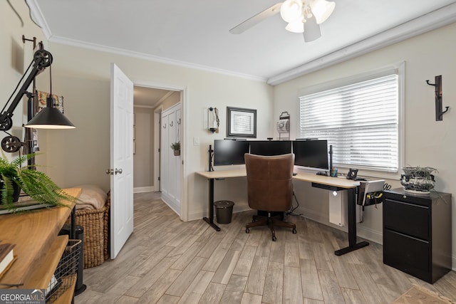 office area with ornamental molding, ceiling fan, light wood-style flooring, and baseboards