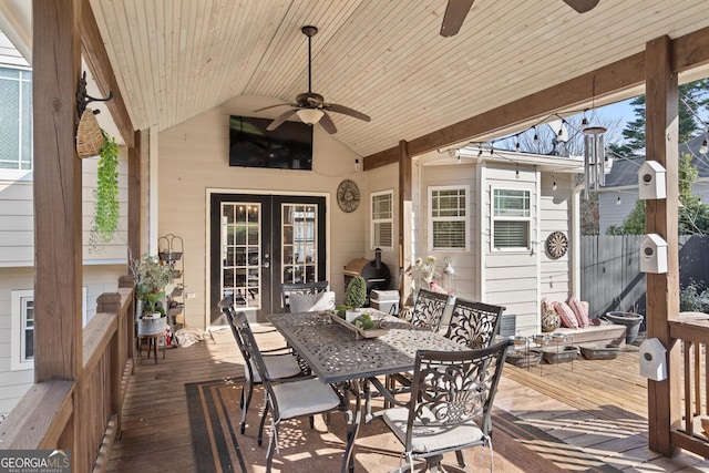 exterior space with outdoor dining area, ceiling fan, a wooden deck, and french doors