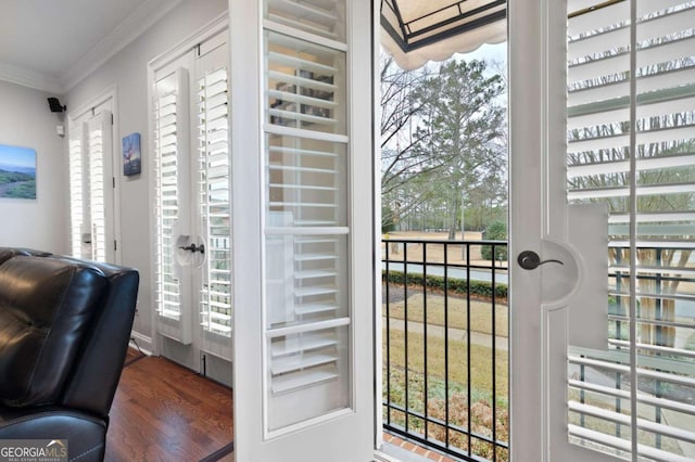 doorway with crown molding and dark hardwood / wood-style floors