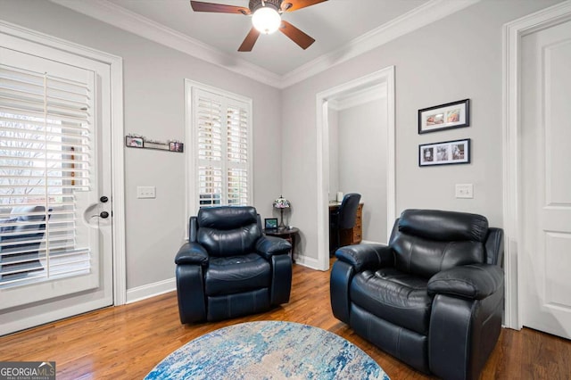 sitting room with ornamental molding, plenty of natural light, and hardwood / wood-style floors