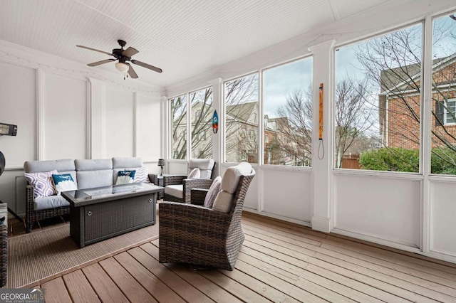 sunroom / solarium with a healthy amount of sunlight and ceiling fan