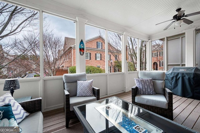 sunroom / solarium with a healthy amount of sunlight and ceiling fan