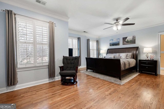 bedroom featuring crown molding, ceiling fan, and light hardwood / wood-style flooring