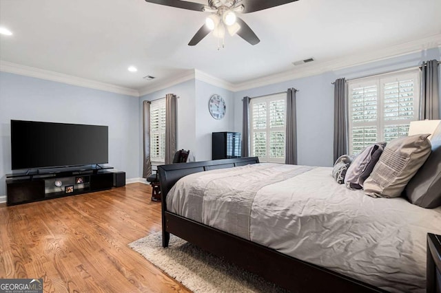 bedroom featuring crown molding, hardwood / wood-style floors, and ceiling fan