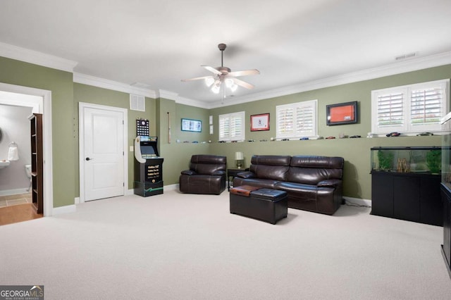 living room with crown molding, ceiling fan, and carpet flooring