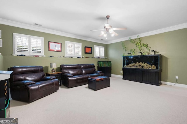 carpeted living room featuring ornamental molding and ceiling fan