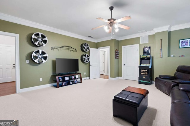 living room featuring ceiling fan, ornamental molding, and carpet flooring