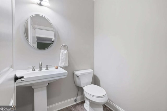 bathroom featuring sink, tile patterned floors, and toilet