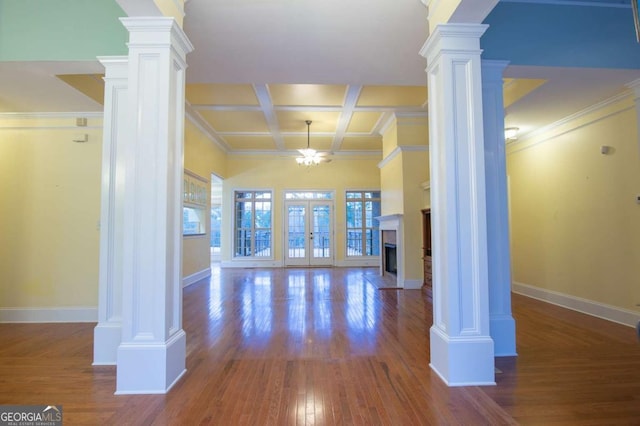 interior space with french doors, decorative columns, coffered ceiling, ceiling fan, and beamed ceiling