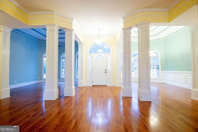 entrance foyer featuring crown molding and plenty of natural light