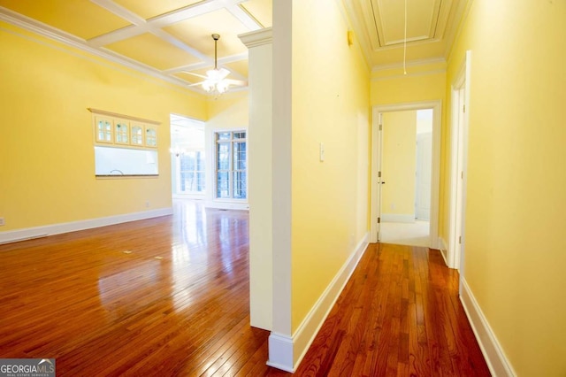 hall with beam ceiling, crown molding, coffered ceiling, and hardwood / wood-style flooring